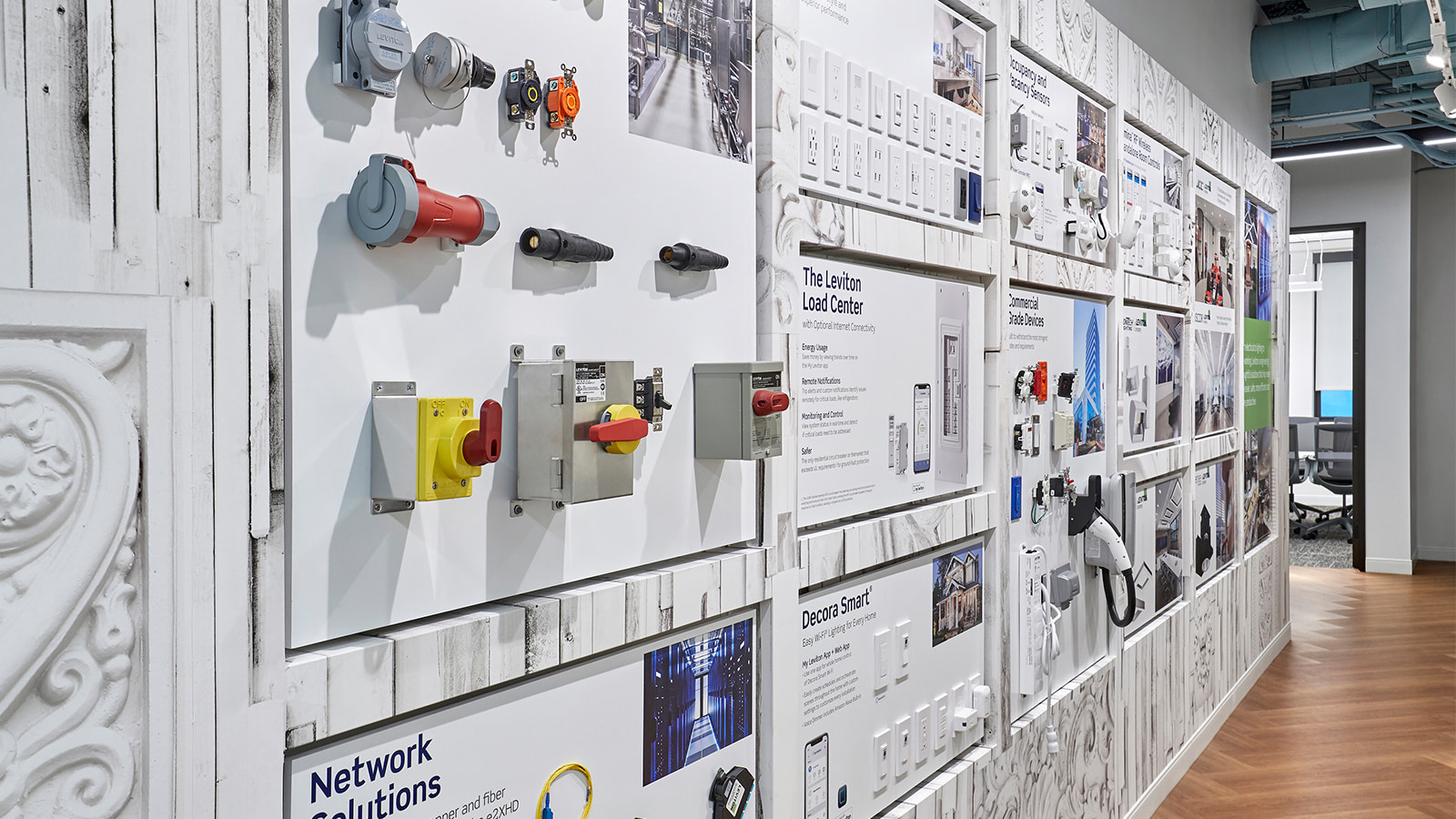 An experiential graphic design display wall at Leviton's showroom