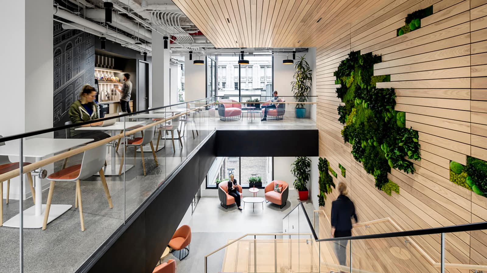 A staircase connects two floors at the NYC Technology Hub of Mastercard designed by IA Interior Architects