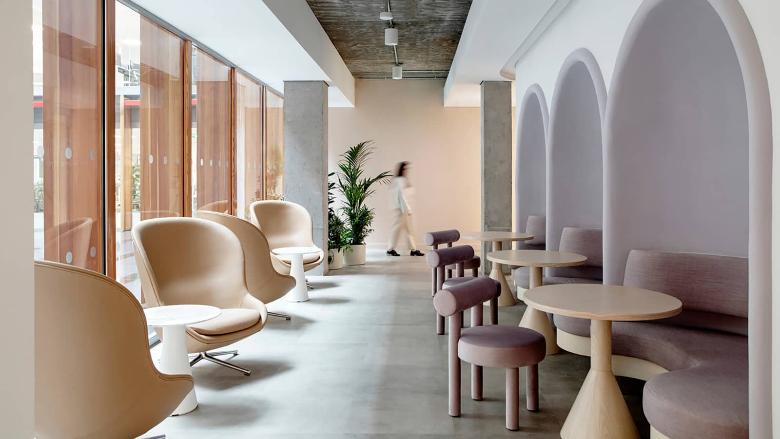 The halls in Dropbox's Dublin offices feature nooks with comfortable pink seats, partnered with open beige armchairs.