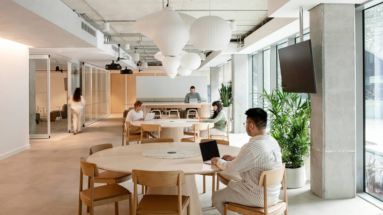 Dropbox's Dublin offices feature a large open area with wide tables, ideal for collaboration.
